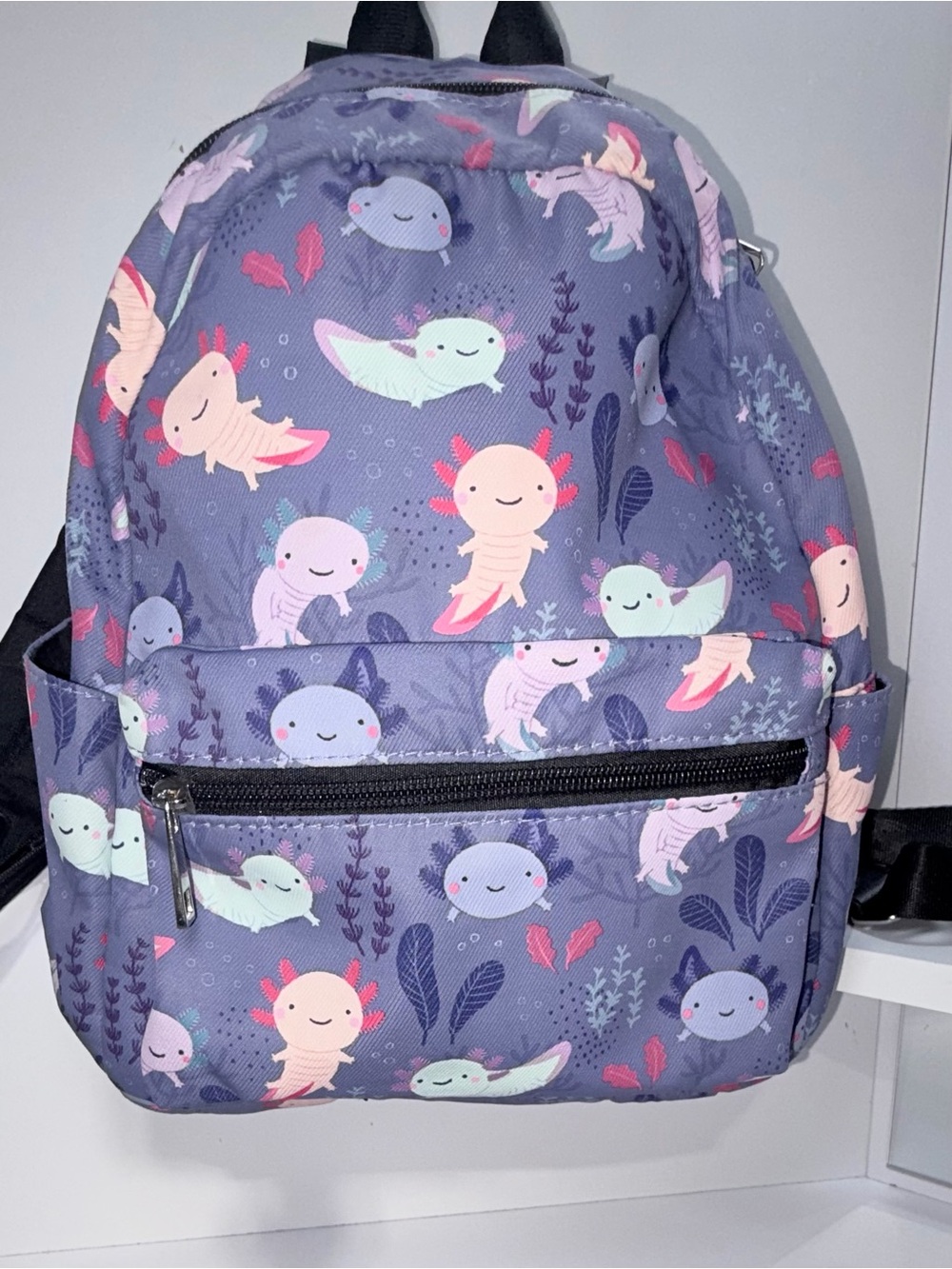 Purple mini backpack featuring an all-over playful axolotl and aquatic plant pri
